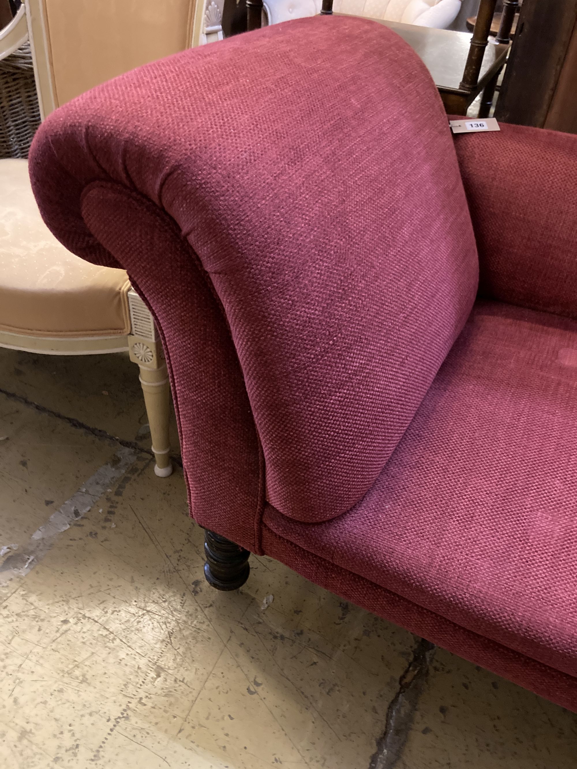 A late Victorian chaise longue, recently upholstered in red fabric, length 168cm, depth 70cm, height 74cm